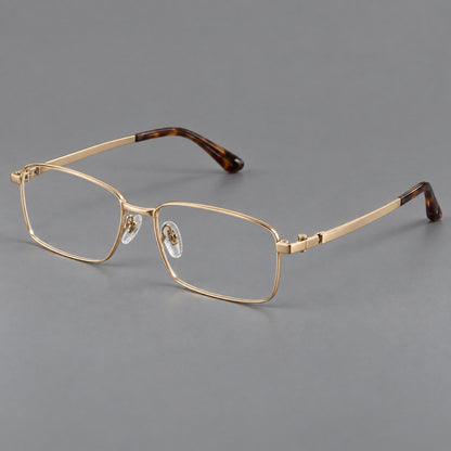 Wide rectangular titanium glasses with a broad bridge and rounded hinge caps in Gold, three quarter view lens detail