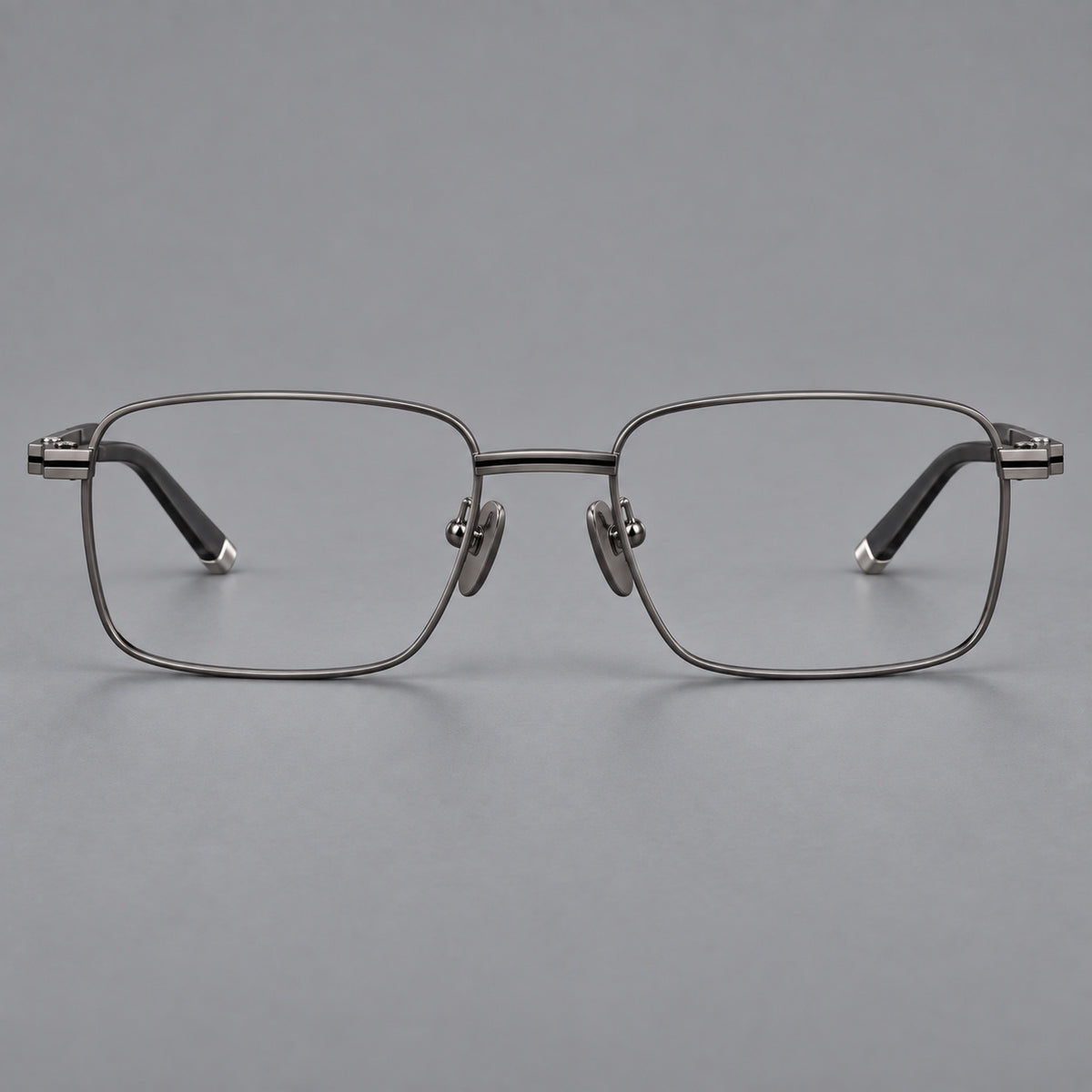 Rectangular titanium glasses with inset corner lines and metal capped temple tips in Gunmetal, front view