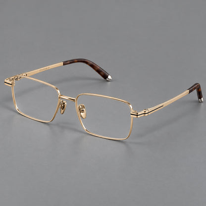 Rectangular titanium glasses with inset corner lines and metal capped temple tips in Gold, three quarter view lens detail