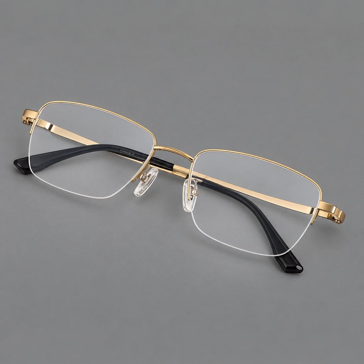 Half frame titanium glasses with rectangular lenses and rounded hinge details in Gold, three quarter view