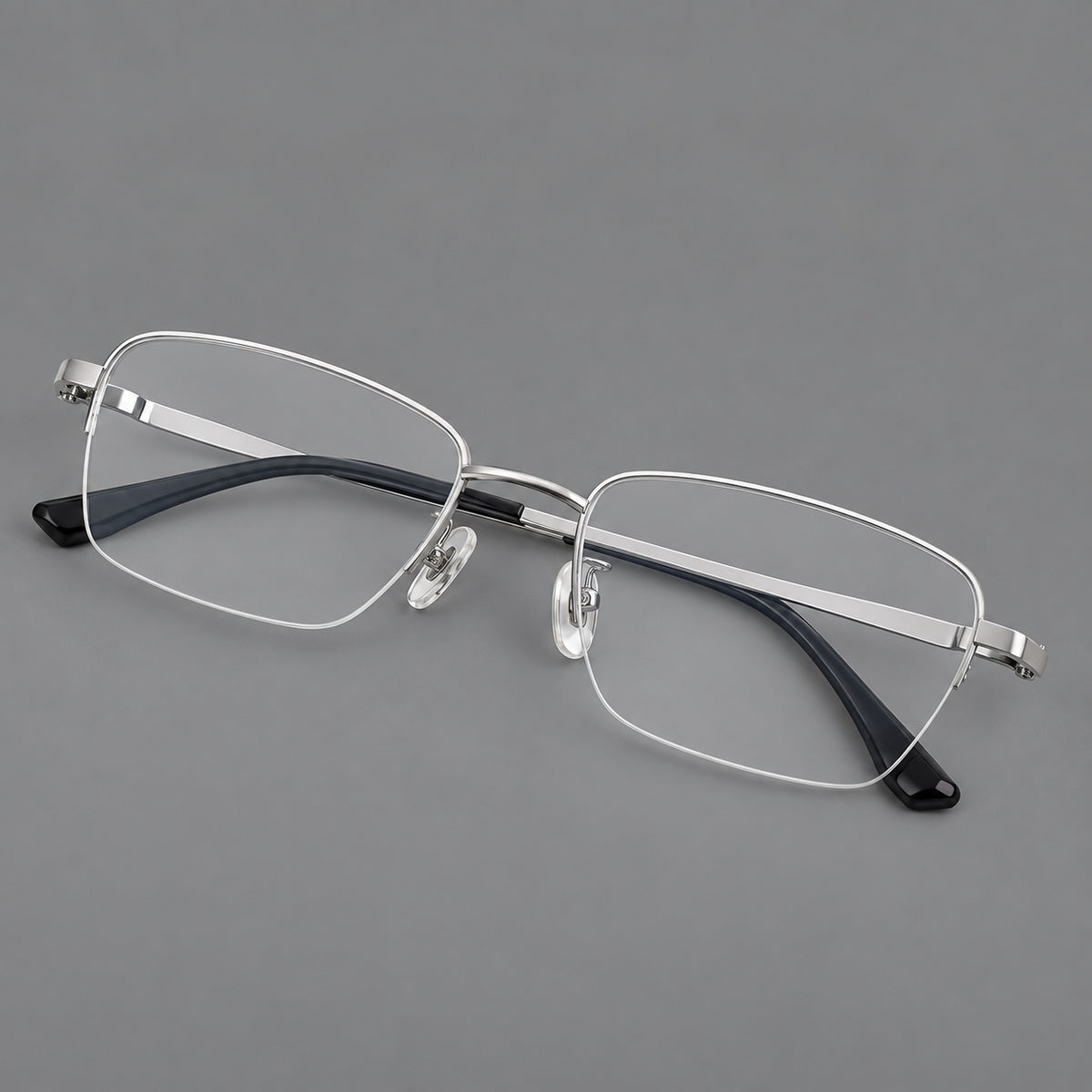 Half frame titanium glasses with rectangular lenses and rounded hinge details in Silver, three quarter view