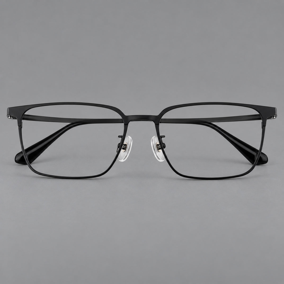 Bold rectangular titanium glasses with strong upper corners and flat metal temples in Black, front view