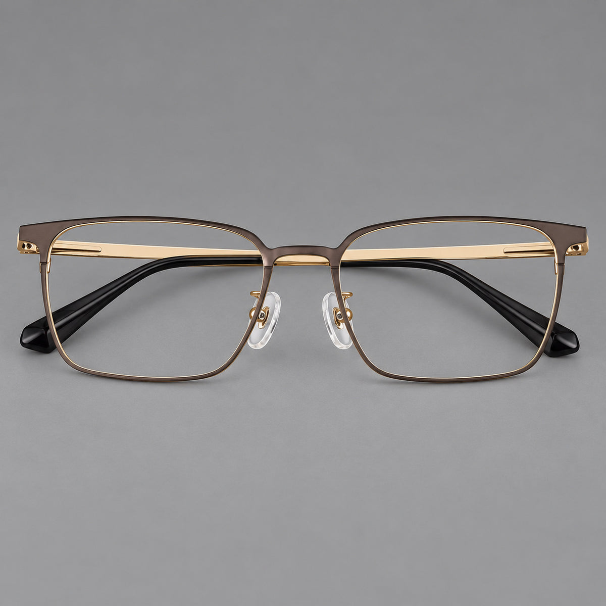Bold rectangular titanium glasses with strong upper corners and flat metal temples in Gold, front view