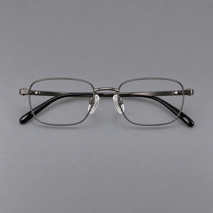 Shallow rectangular titanium glasses with a broad bridge and stepped temple joins in Gunmetal, front view frame detail