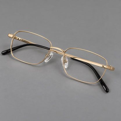 Shallow rectangular titanium glasses with a broad bridge and stepped temple joins in Gold, three quarter view lens detail