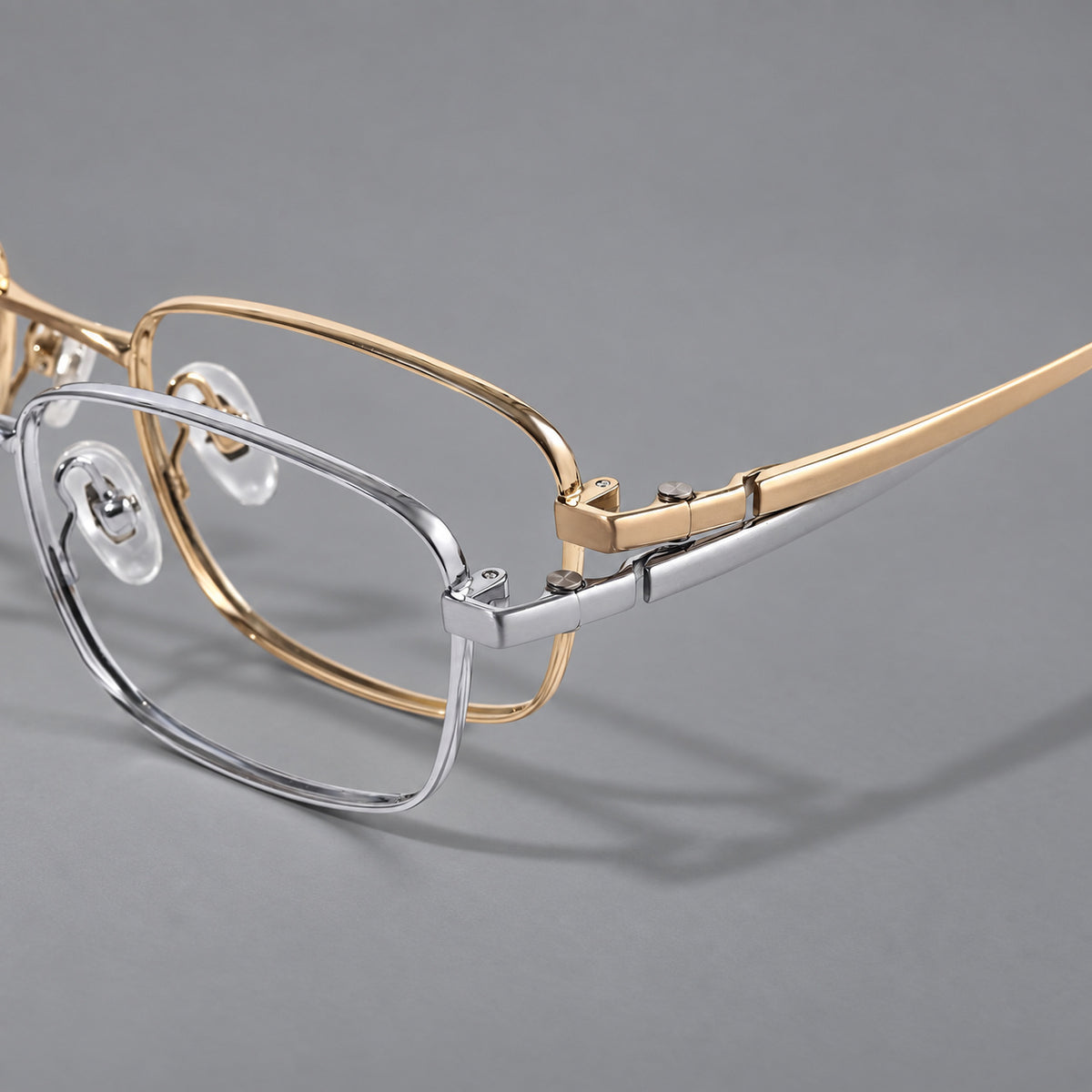 Shallow rectangular titanium glasses with a broad bridge and stepped temple joins, frame details